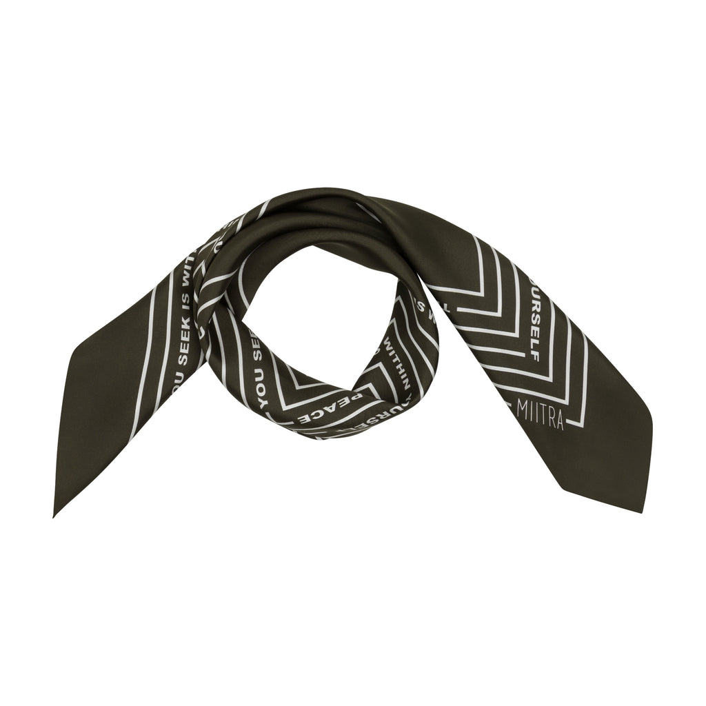 Styled view of an olive brown silk scarf wrapped around in a circle