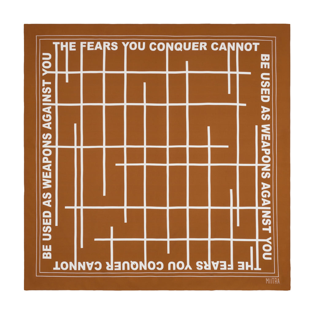 Brown silk scarf that says the fears you conquer cannot be used as weapons against you